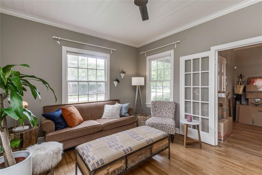 Living area with hardwood floors and abundant natural light