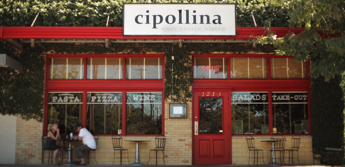 Cipollina restaurant storefront with red windows and outdoor seating in Historic Clarksville