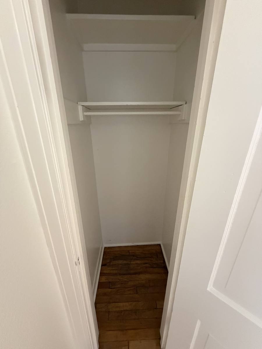 Additional storage closet with hanging rod and shelf